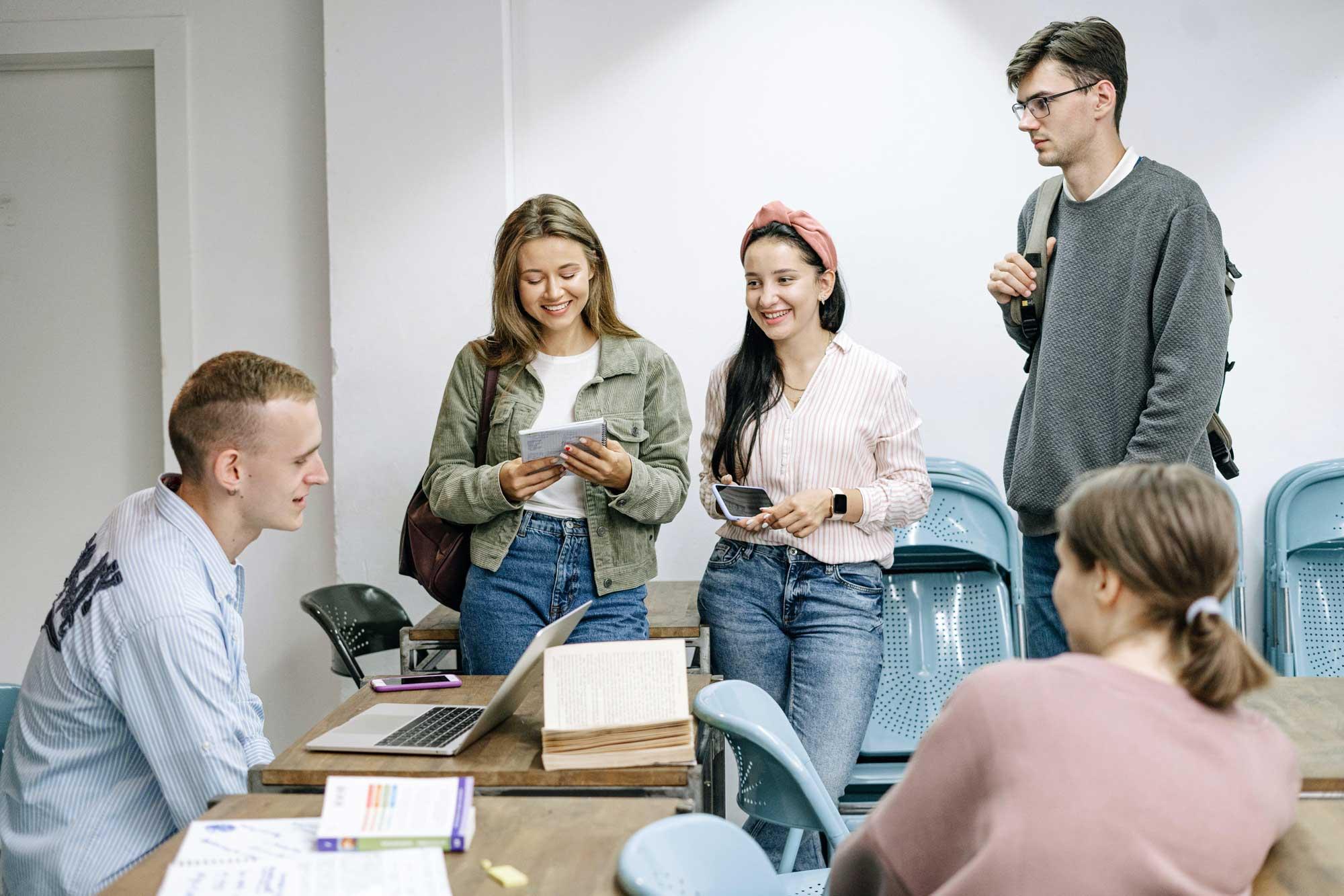 19+ group of friends talking around a table