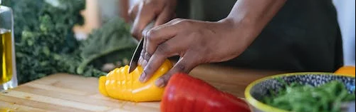 photo of person cutting bell peppers