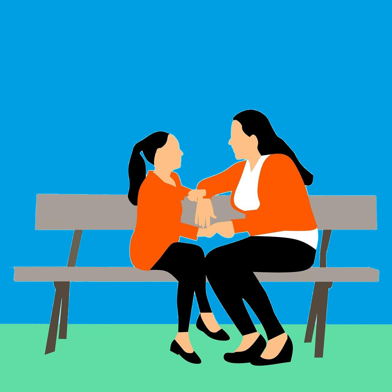 Communication and language development - woman and her daughter sitting on a bench talking